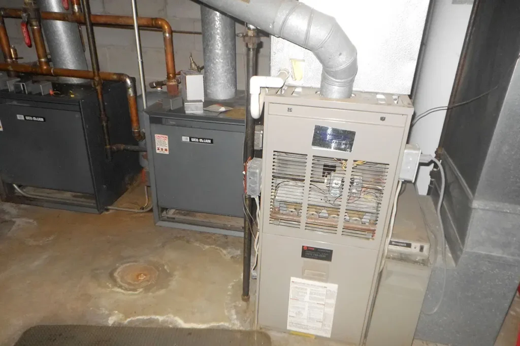 Basement furnace and boiler system with pipes and venting, energy-efficient heating, residential HVAC installation.