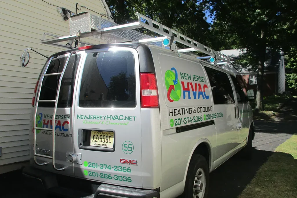 New Jersey HVAC service van with ladder, contact info, and logo, parked in residential driveway under trees.